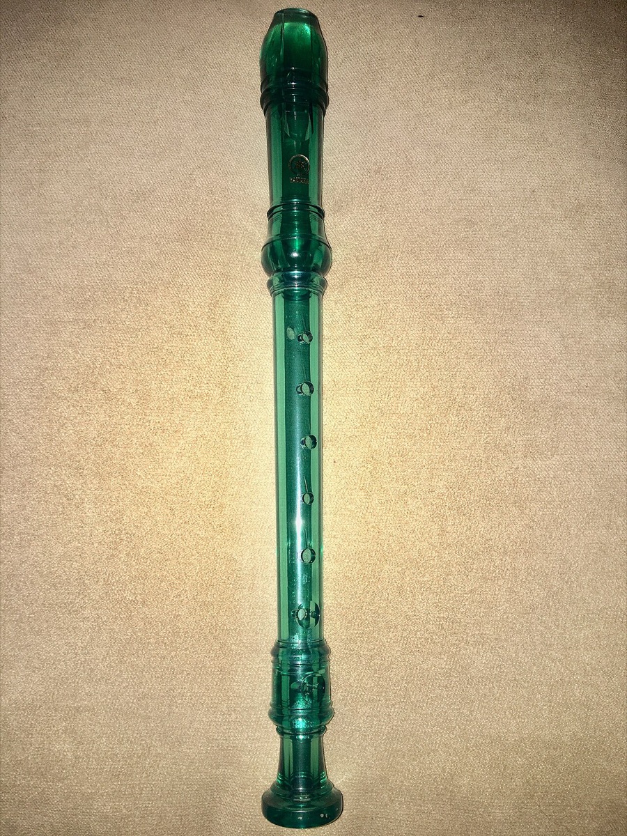 A translucent green Yamaha plastic soprano recorder — the standard school music-class model