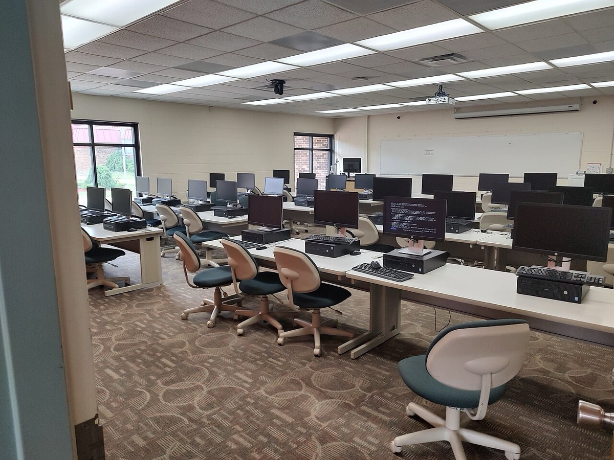 Rows of desktop computers in a school computer lab — where a generation played Cool Math Games