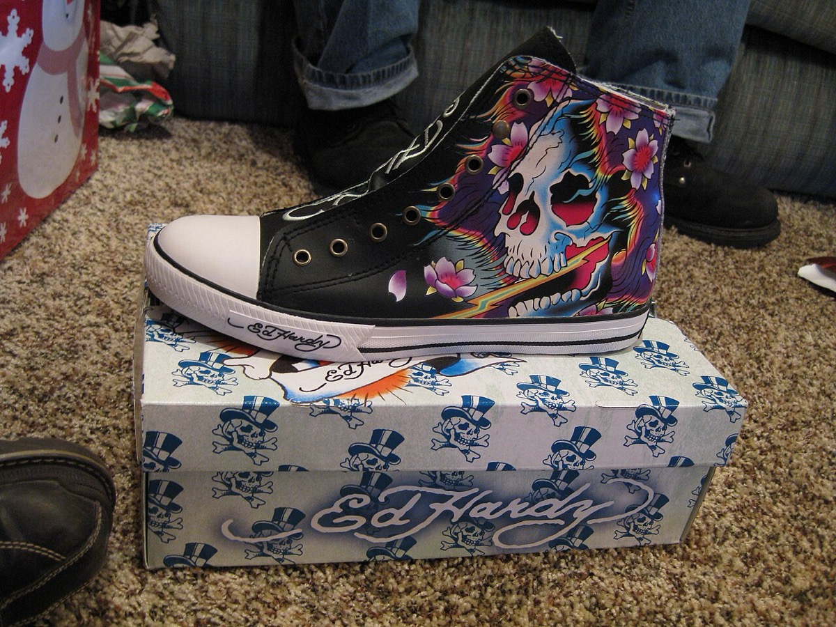 an Ed Hardy tattoo-art high-top sneaker on its branded box