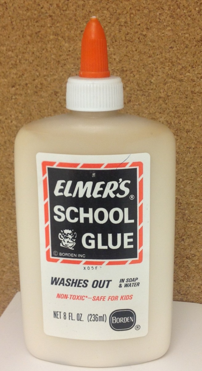 A vintage Borden-era Elmer's School Glue bottle with the orange twist cap and Elmer the bull on the label