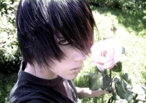 Close-up portrait of a person with a classic emo swoop haircut holding a rose