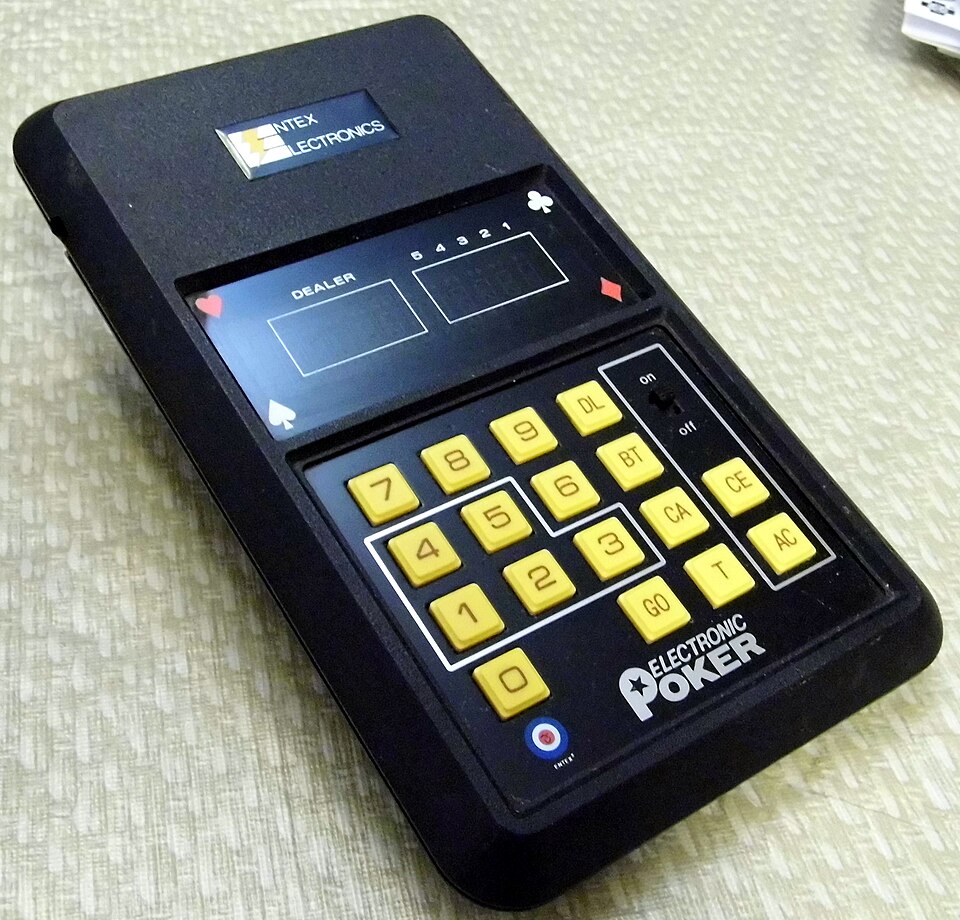 An Entex Electronics 'Electronic Poker' handheld game with card-suit symbols and a yellow keypad — an early pocket electronic casino game