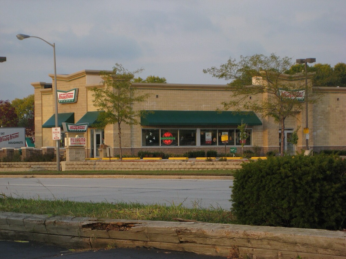 A Krispy Kreme storefront in West Allis, Wisconsin in 2008, neon Doughnuts sign glowing in the window