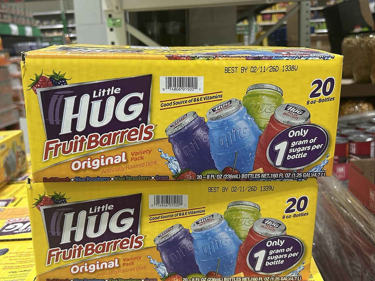Cases of Little Hug Fruit Barrels on a store shelf, the classic barrel bottles pictured on the box art