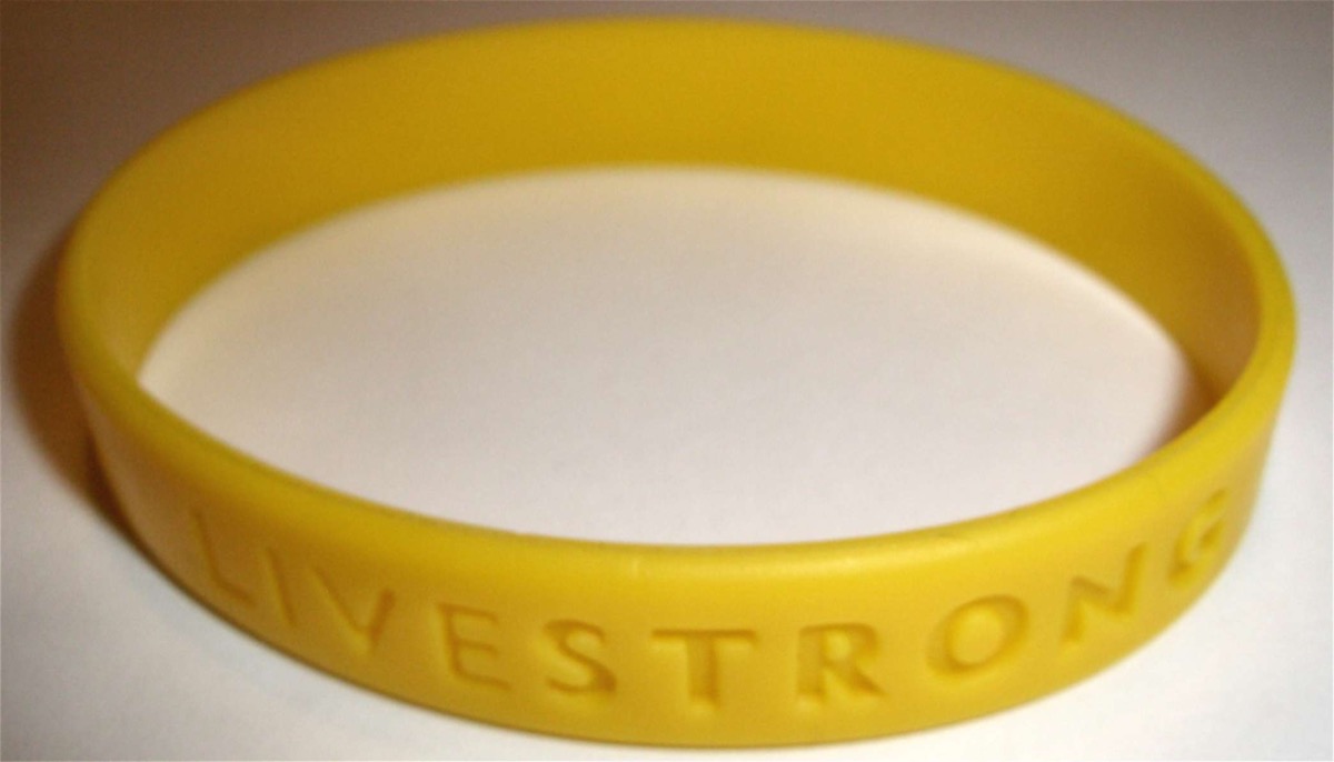 A yellow silicone LIVESTRONG wristband on a plain background
