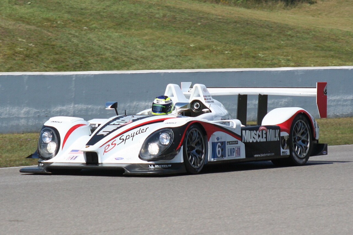 The Muscle Milk Team CytoSport Porsche RS Spyder race car — the brand's own prototype racing team — on track in its white, black, and red livery