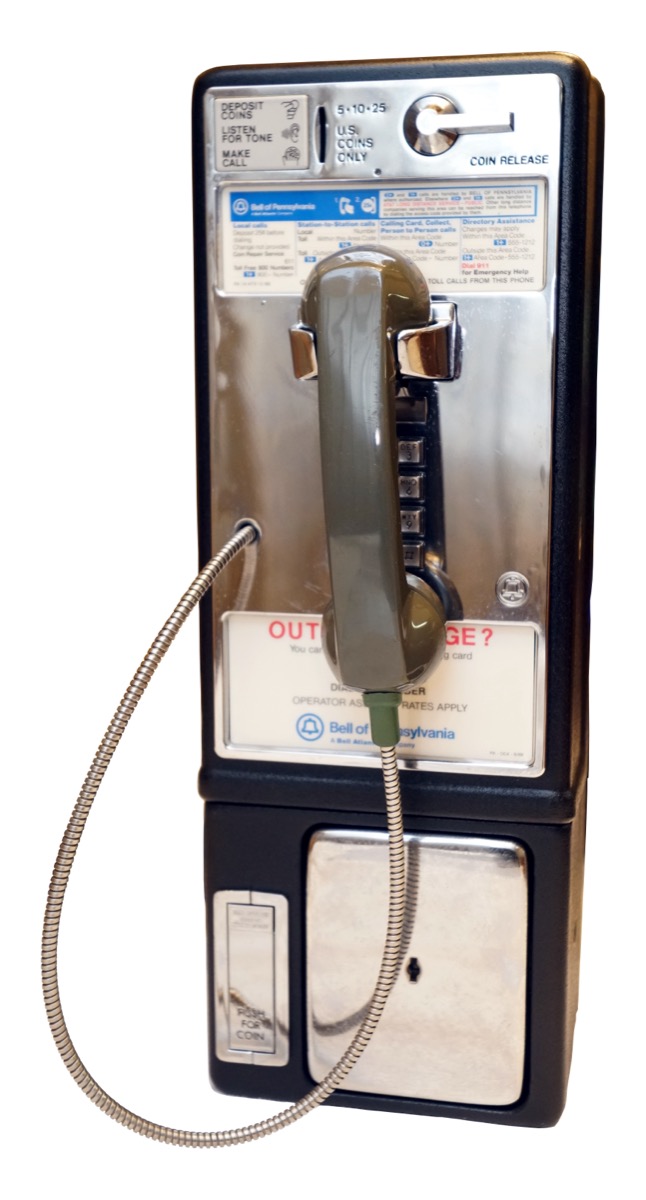 A Bell of Pennsylvania coin-operated payphone with a chrome faceplate, dial-instruction card, and metal-armored handset cord