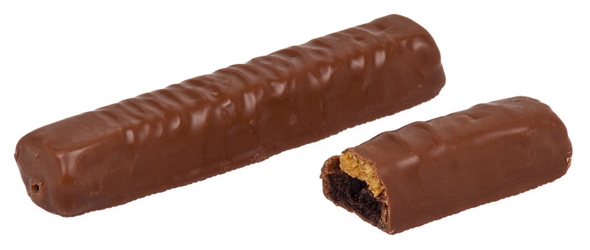A Peanut Butter Twix bar broken open, showing the peanut butter filling atop the chocolate cookie