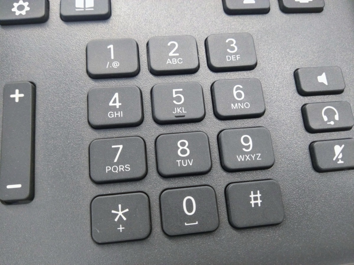 Close-up of a landline telephone number keypad showing the 1-9, 0, star and pound keys with letter groupings