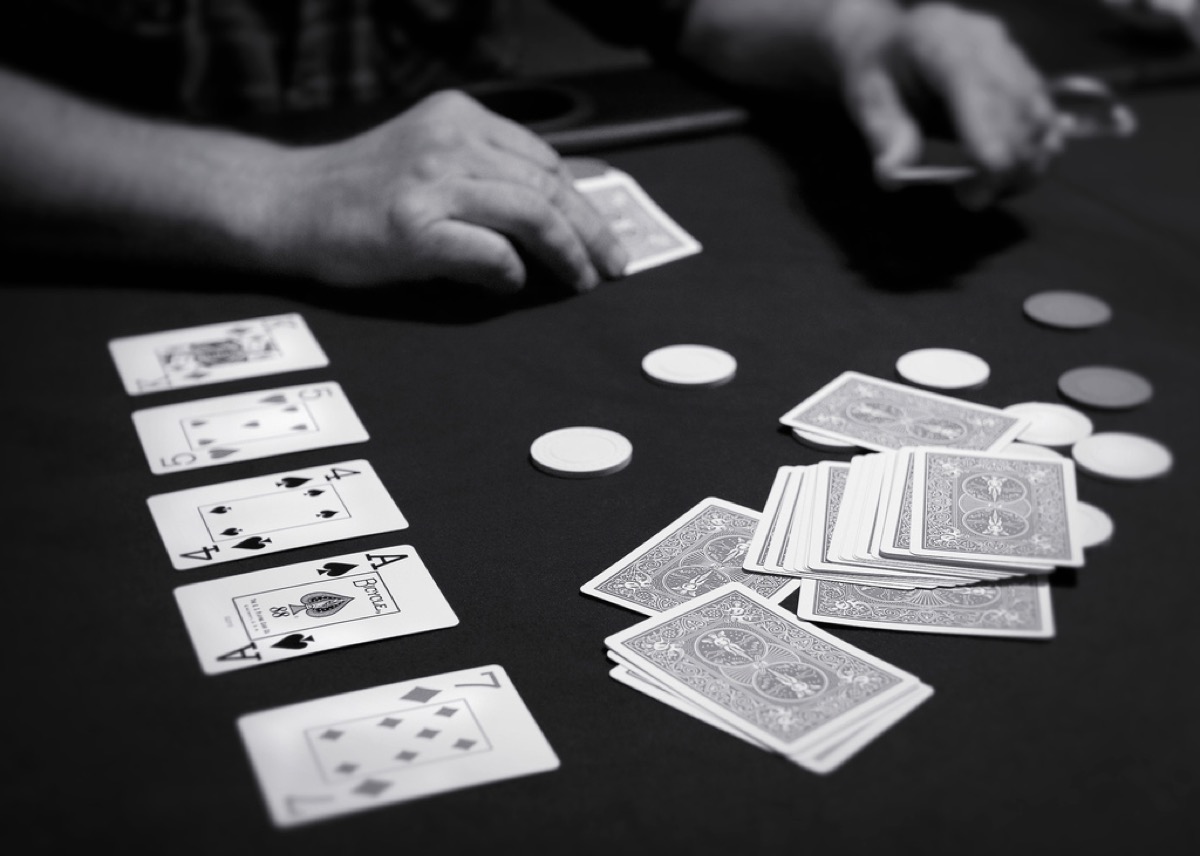 Community cards, hole cards, and chips on a Texas hold'em table