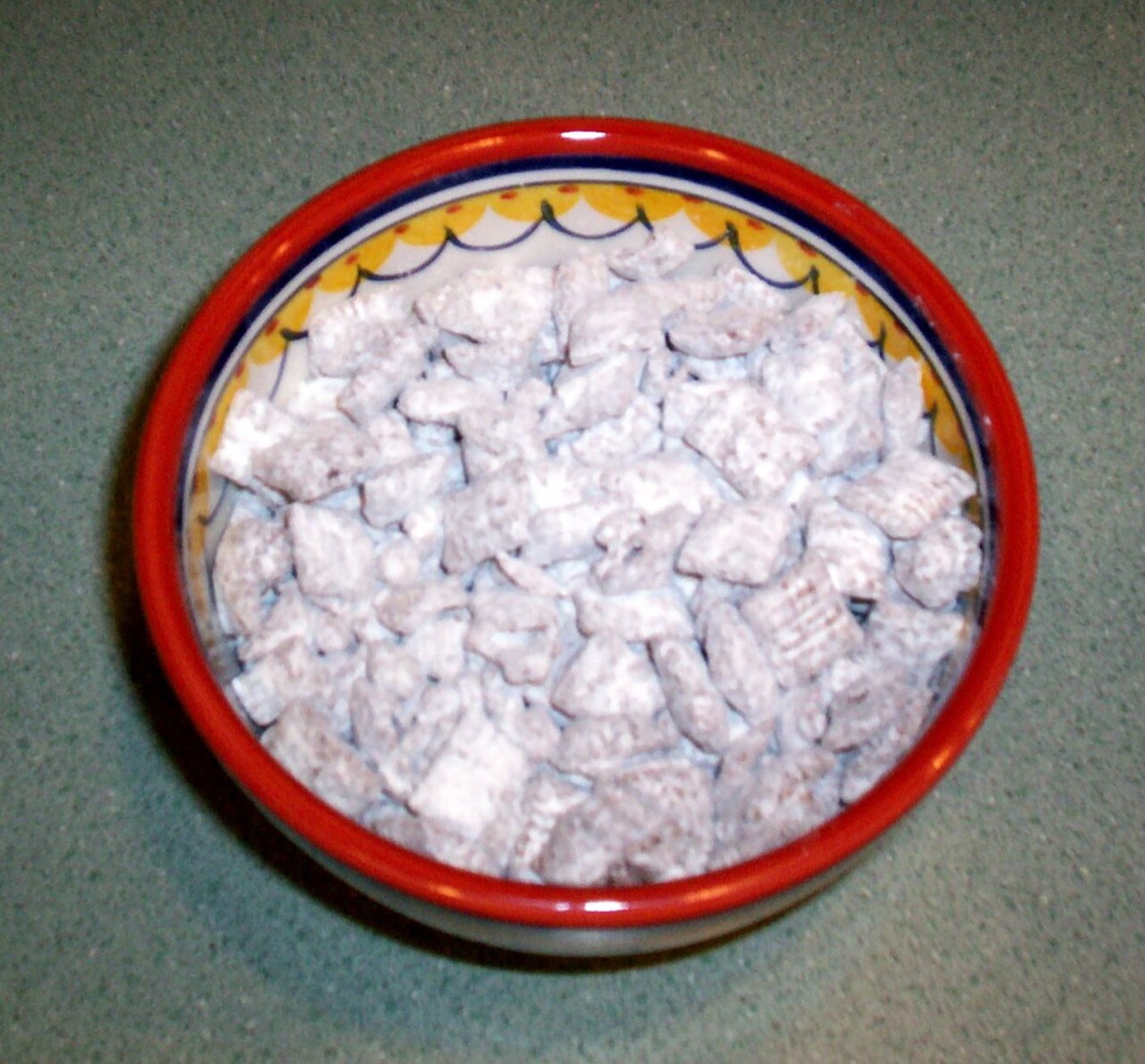 A bowl of homemade puppy chow — powdered-sugar-coated Chex squares