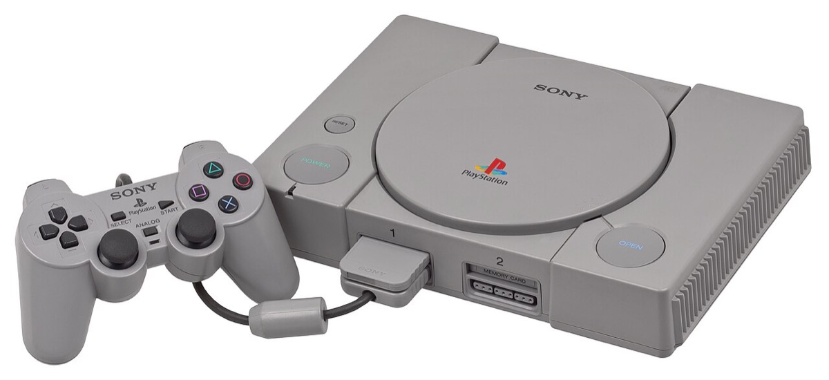 An original gray Sony PlayStation console with its controller — the platform Resident Evil launched on