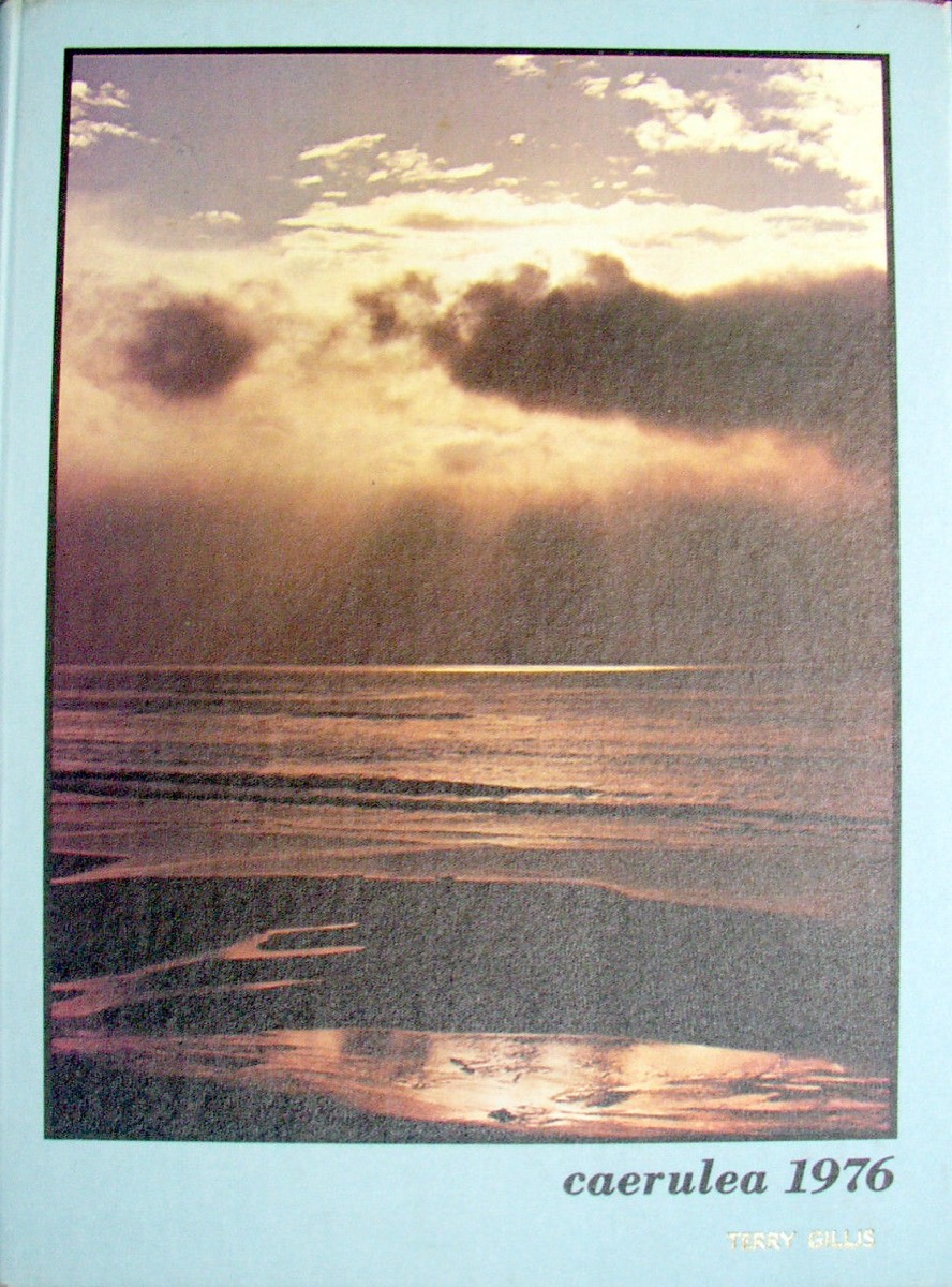 The cloth hardcover of a 1976 school yearbook, embossed 'caerulea 1976' over a sunset-ocean cover photo