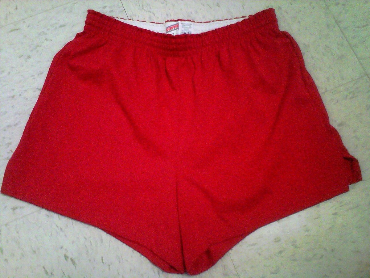 A pair of red Soffe gym shorts laid flat, with the logo waistband showing