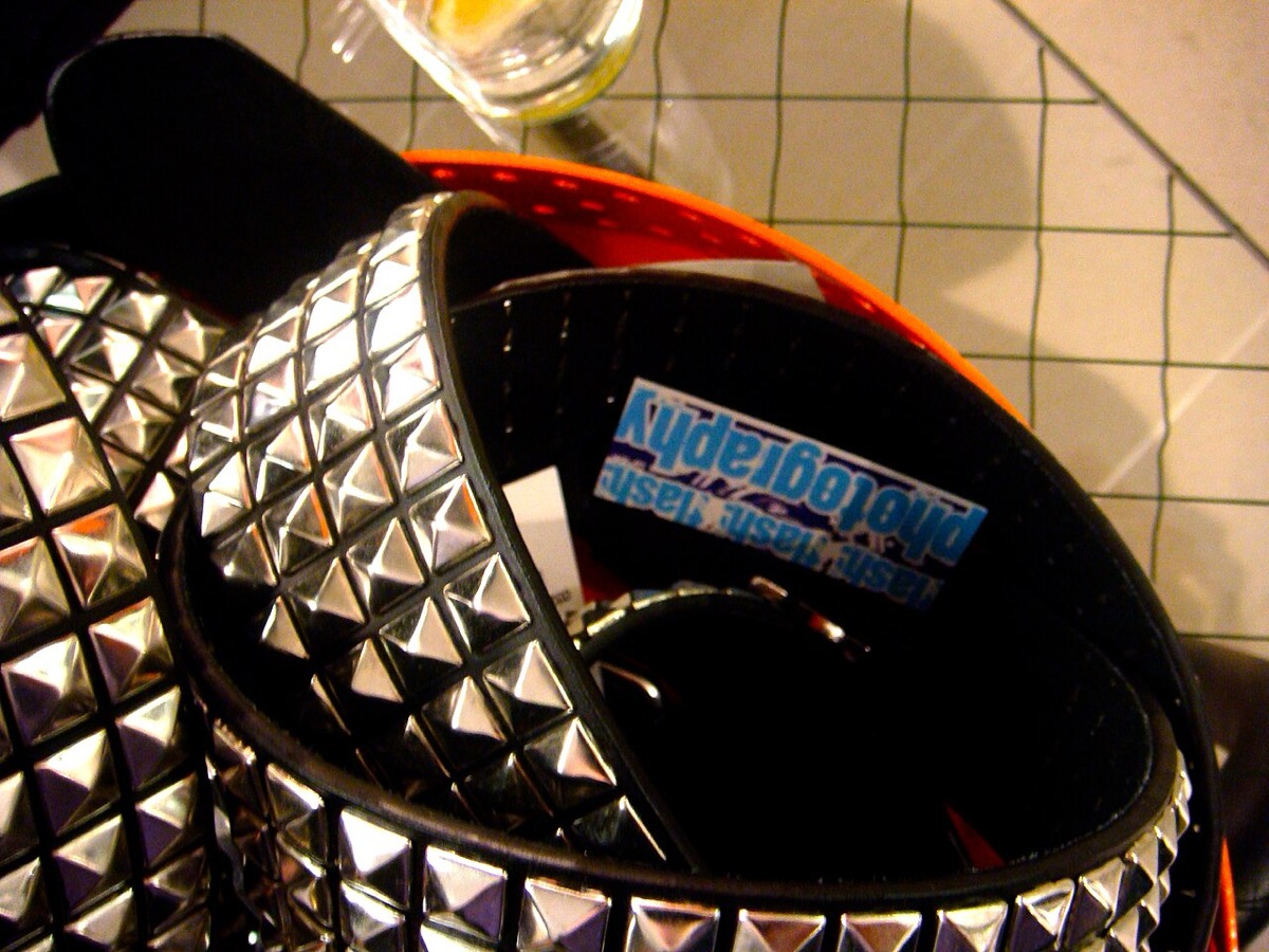 Coiled black belts covered in rows of chrome pyramid studs