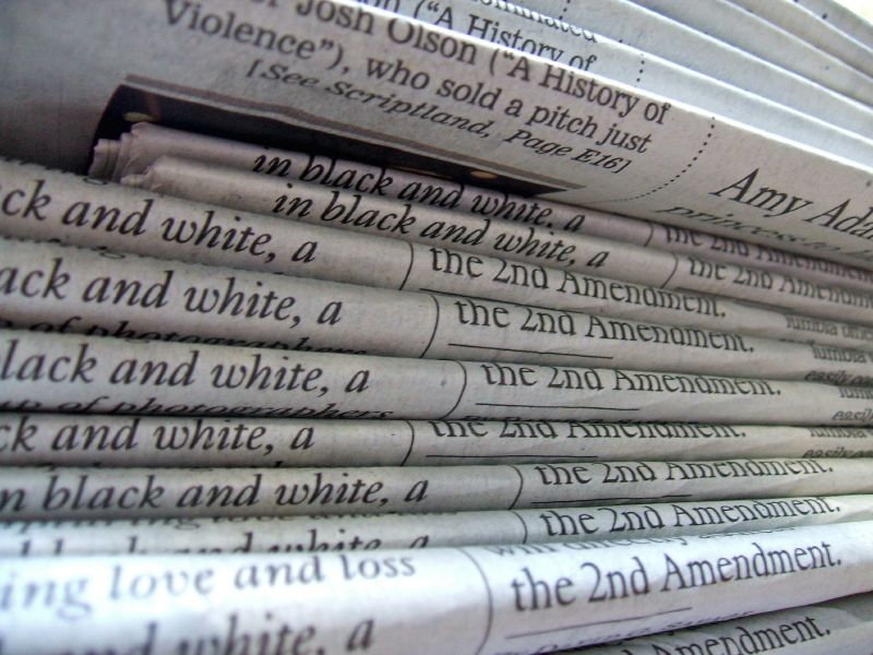 A close-up stack of folded newspapers