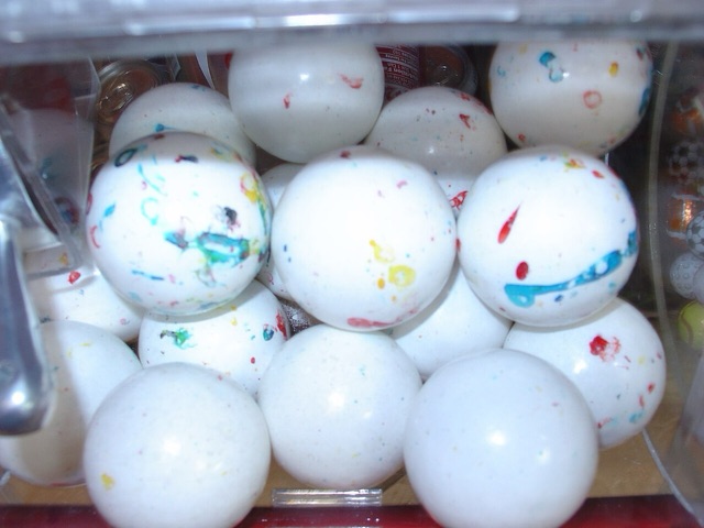 A bin full of large speckled, marbled giant jawbreaker candies