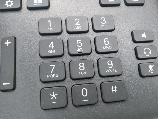 Close-up of a landline telephone number keypad showing the 1-9, 0, star and pound keys with letter groupings