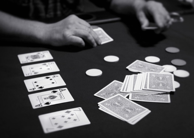 Community cards, hole cards, and chips on a Texas hold'em table