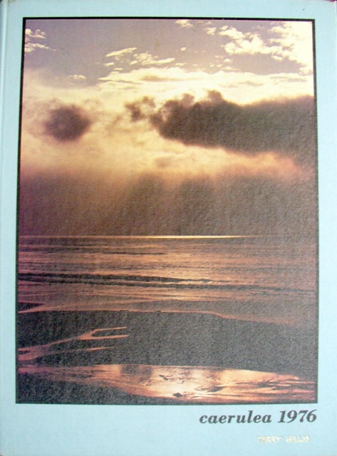 The cloth hardcover of a 1976 school yearbook, embossed 'caerulea 1976' over a sunset-ocean cover photo