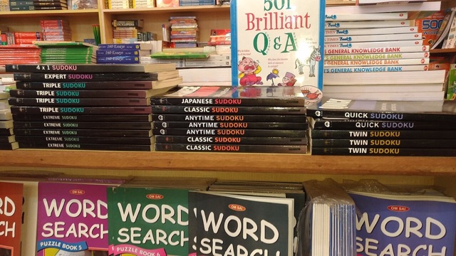 Bookshop shelves stacked with sudoku puzzle books