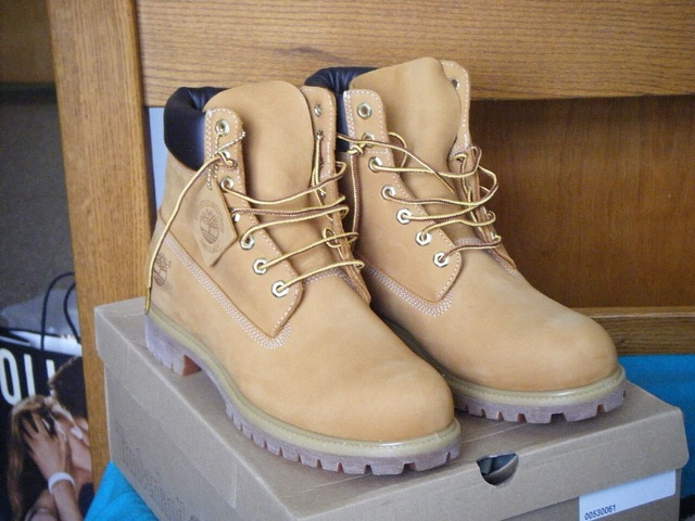 A pair of wheat-colored Timberland six-inch boots on their box