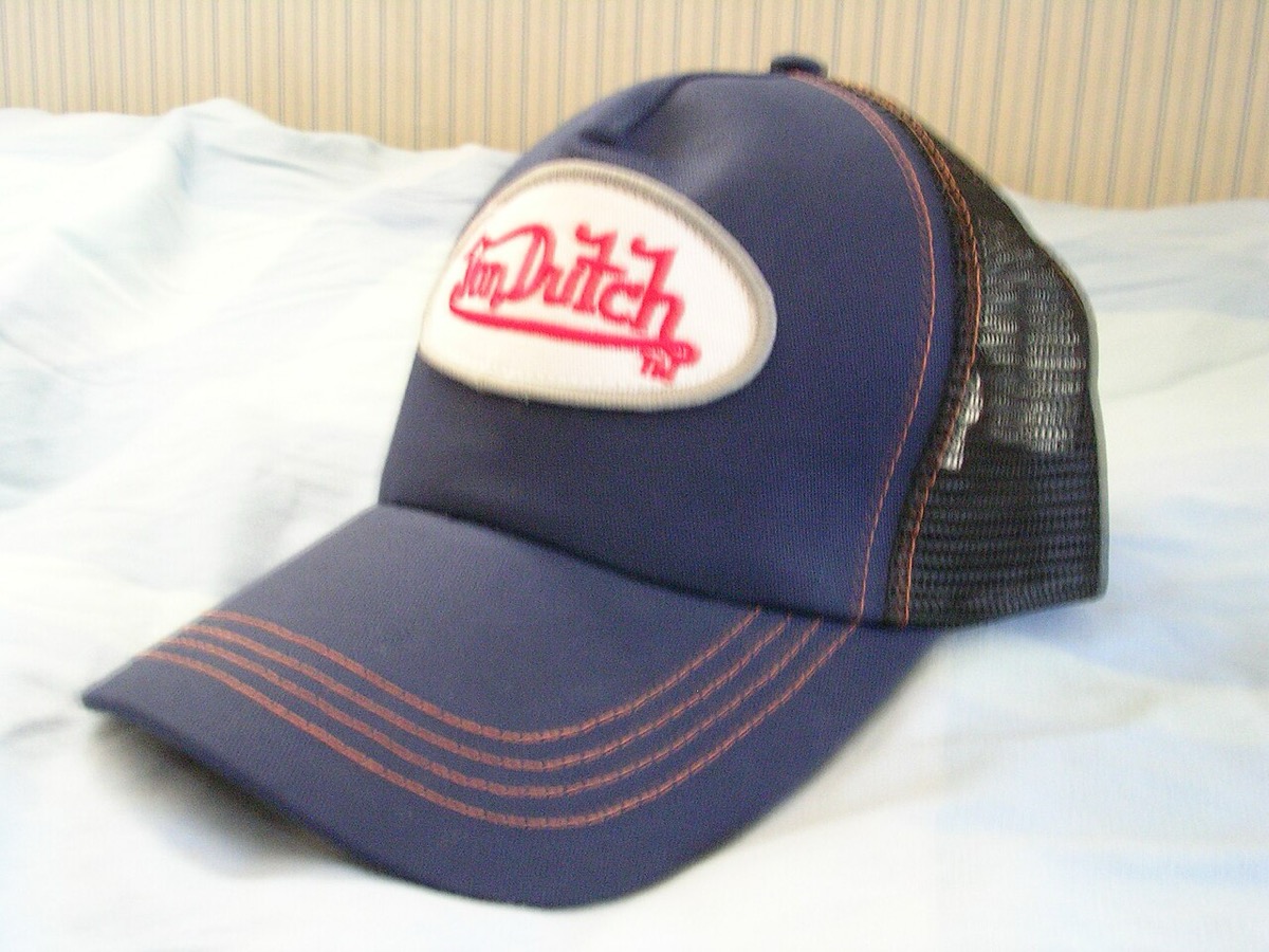 A navy blue Von Dutch mesh trucker hat with the embroidered logo patch
