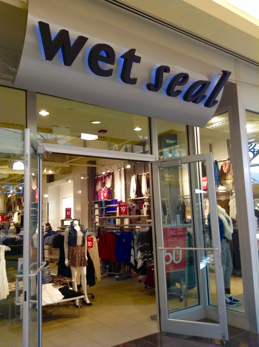 A Wet Seal mall storefront with its black script sign and juniors racks visible inside